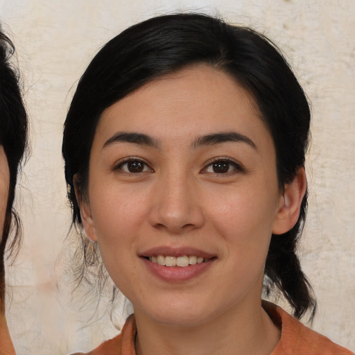 Joyful asian young-adult female with medium  brown hair and brown eyes