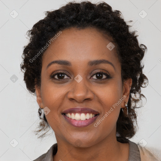 Joyful black young-adult female with long  brown hair and brown eyes