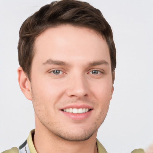 Joyful white young-adult male with short  brown hair and grey eyes