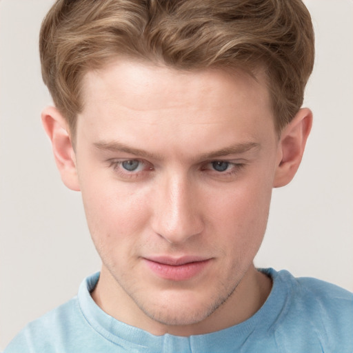 Joyful white young-adult male with short  brown hair and blue eyes