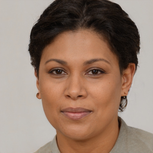 Joyful black adult female with short  brown hair and brown eyes