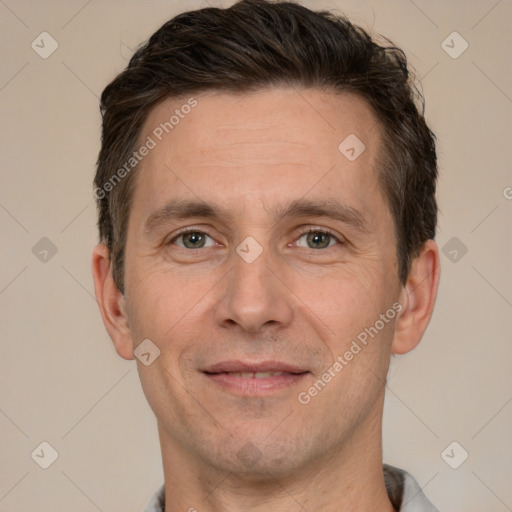 Joyful white adult male with short  brown hair and brown eyes