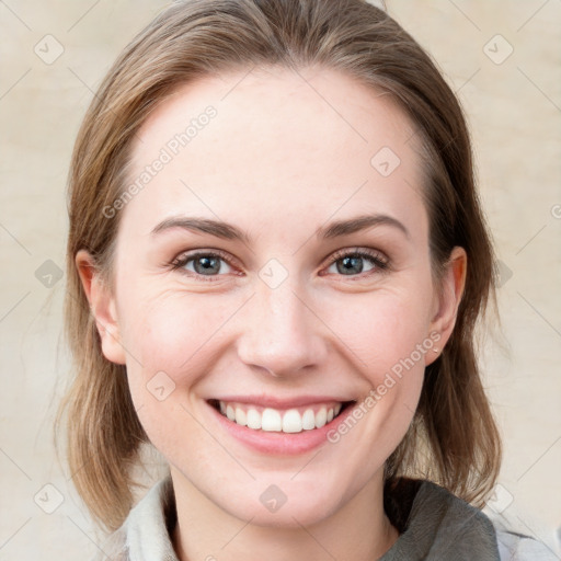 Joyful white young-adult female with medium  brown hair and blue eyes