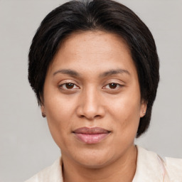 Joyful asian adult female with short  brown hair and brown eyes