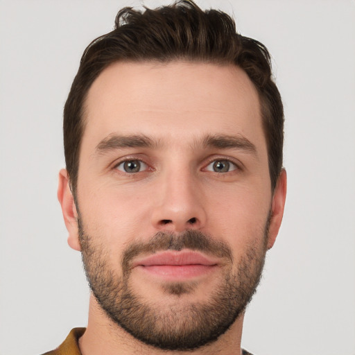 Joyful white young-adult male with short  brown hair and brown eyes