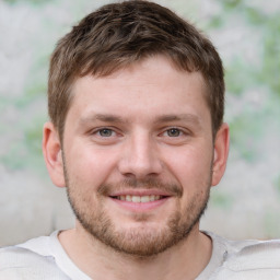 Joyful white young-adult male with short  brown hair and brown eyes