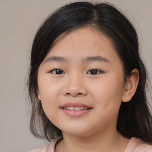 Joyful asian child female with medium  brown hair and brown eyes