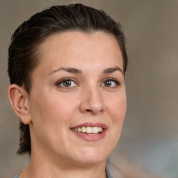 Joyful white adult female with medium  brown hair and brown eyes