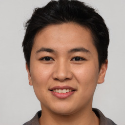 Joyful asian young-adult male with short  brown hair and brown eyes