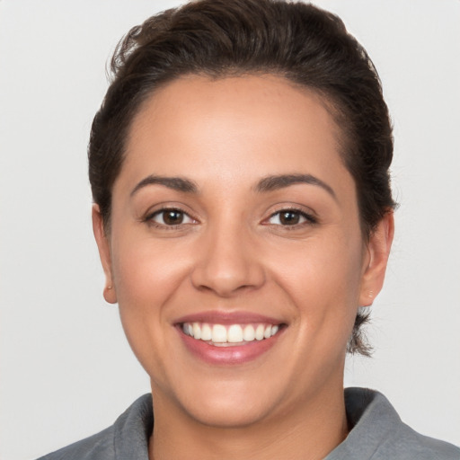 Joyful white young-adult female with short  brown hair and brown eyes