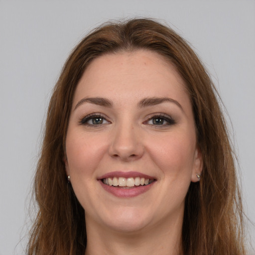 Joyful white young-adult female with long  brown hair and grey eyes