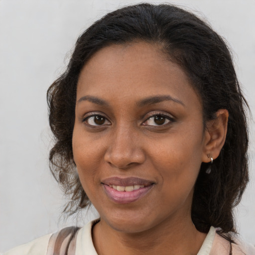 Joyful black young-adult female with medium  brown hair and brown eyes