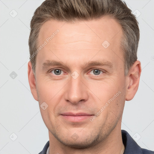 Joyful white adult male with short  brown hair and grey eyes