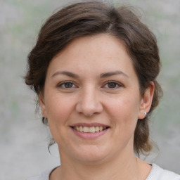 Joyful white young-adult female with medium  brown hair and brown eyes