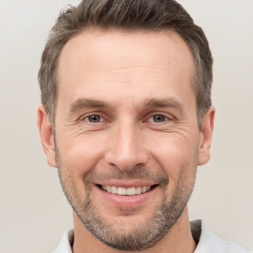 Joyful white adult male with short  brown hair and brown eyes