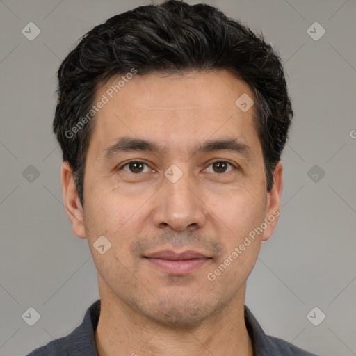 Joyful white adult male with short  black hair and brown eyes