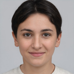 Joyful white young-adult female with short  brown hair and grey eyes