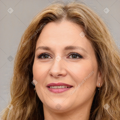 Joyful white adult female with long  brown hair and brown eyes