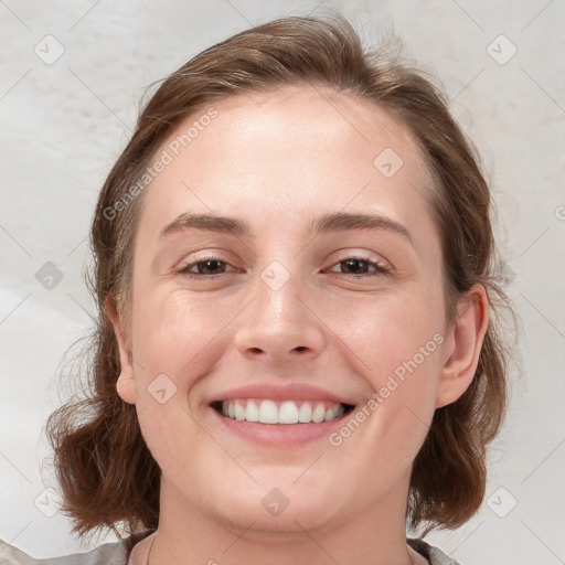 Joyful white young-adult female with medium  brown hair and blue eyes