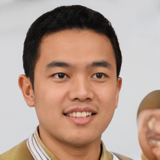 Joyful white young-adult male with short  black hair and brown eyes