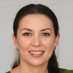 Joyful white young-adult female with medium  brown hair and brown eyes