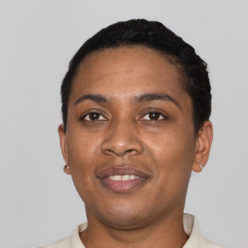Joyful black young-adult female with short  black hair and brown eyes
