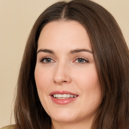 Joyful white young-adult female with long  brown hair and brown eyes