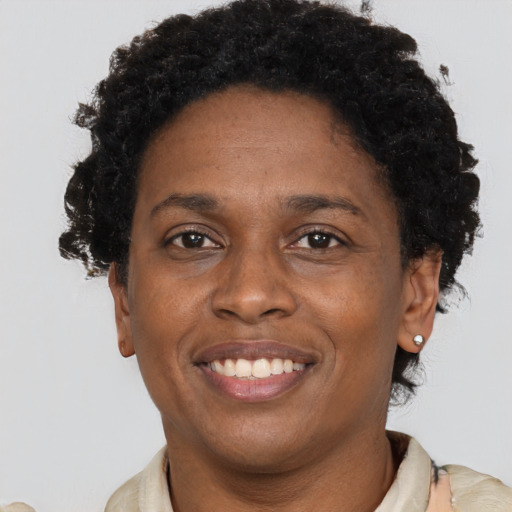 Joyful black young-adult female with short  brown hair and brown eyes