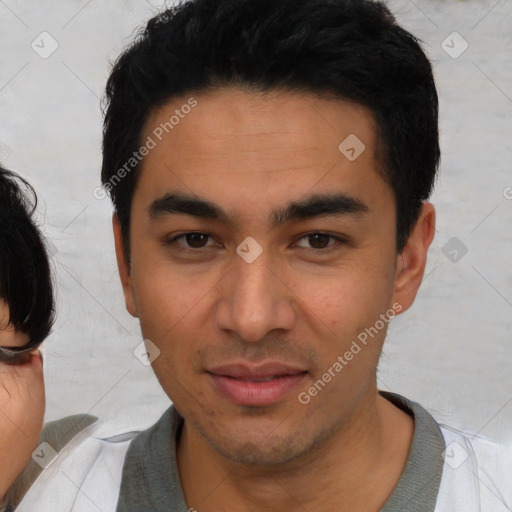 Joyful asian young-adult male with short  black hair and brown eyes