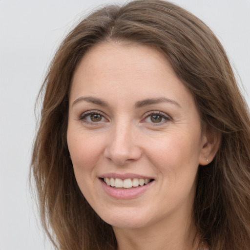 Joyful white young-adult female with long  brown hair and grey eyes