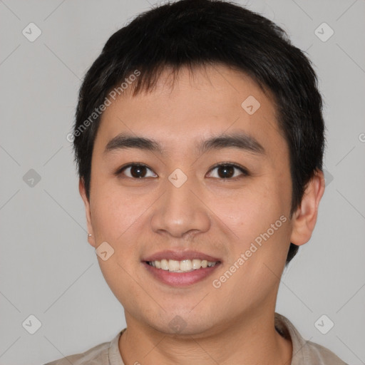 Joyful asian young-adult male with short  brown hair and brown eyes