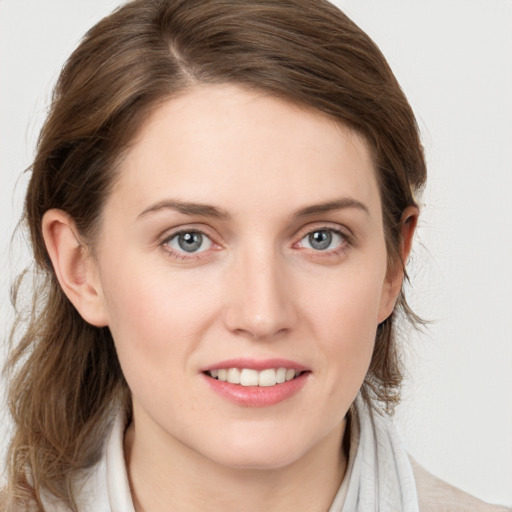 Joyful white young-adult female with medium  brown hair and blue eyes