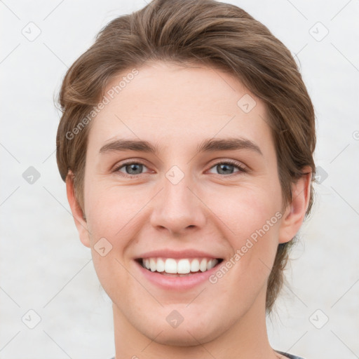 Joyful white young-adult female with short  brown hair and grey eyes