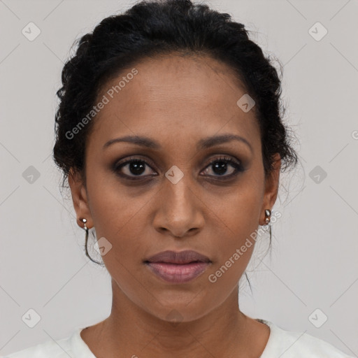 Joyful black adult female with short  brown hair and brown eyes