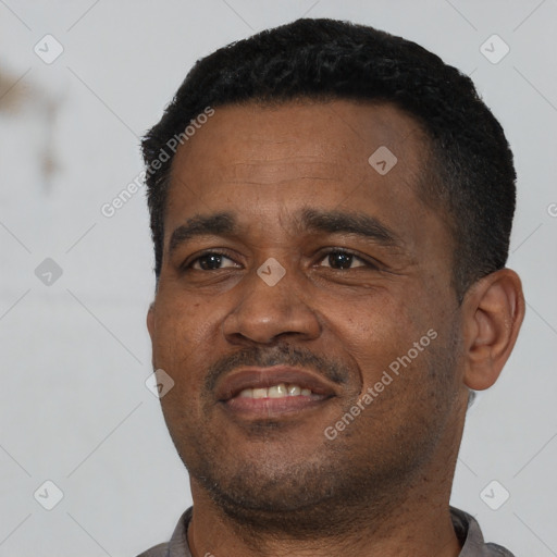 Joyful latino adult male with short  black hair and brown eyes