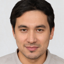 Joyful white young-adult male with short  black hair and brown eyes