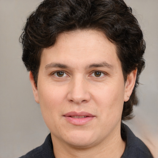 Joyful white adult male with medium  brown hair and brown eyes