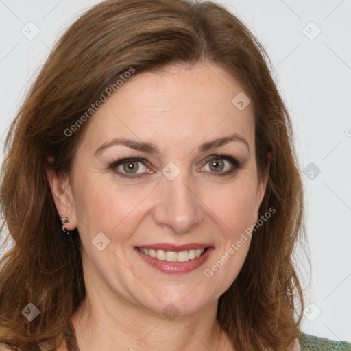 Joyful white adult female with medium  brown hair and green eyes