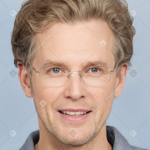 Joyful white adult male with short  brown hair and grey eyes