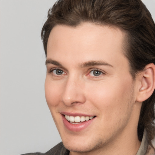 Joyful white young-adult male with medium  brown hair and brown eyes