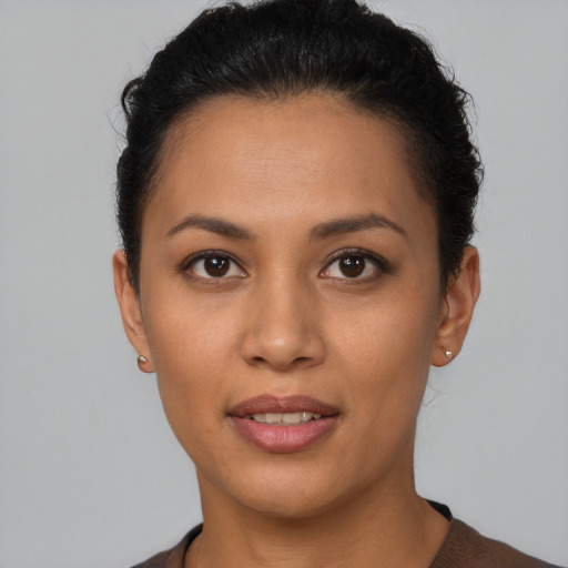 Joyful latino young-adult female with short  brown hair and brown eyes