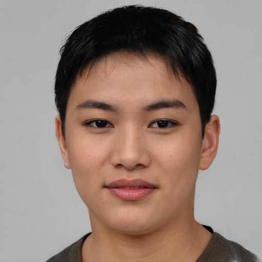 Joyful asian young-adult male with short  black hair and brown eyes