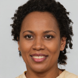 Joyful black adult female with short  brown hair and brown eyes