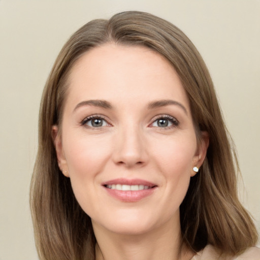 Joyful white young-adult female with long  brown hair and grey eyes