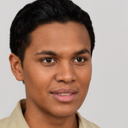 Joyful latino young-adult male with short  brown hair and brown eyes