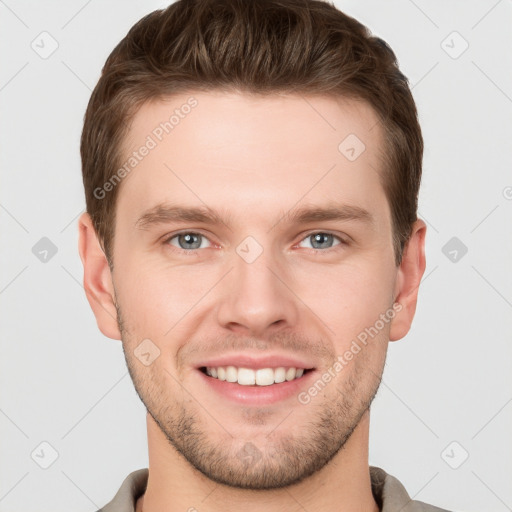 Joyful white young-adult male with short  brown hair and grey eyes