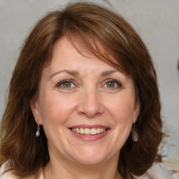 Joyful white adult female with medium  brown hair and grey eyes