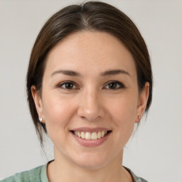 Joyful white young-adult female with medium  brown hair and brown eyes