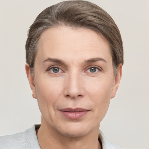 Joyful white adult female with short  brown hair and grey eyes