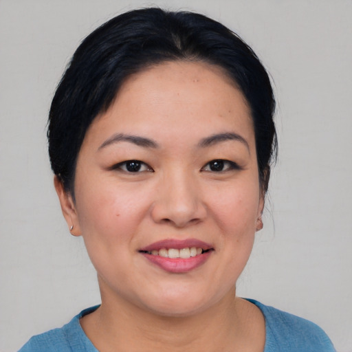 Joyful asian young-adult female with medium  black hair and brown eyes